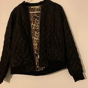 black jacket with cheetah print on the inside